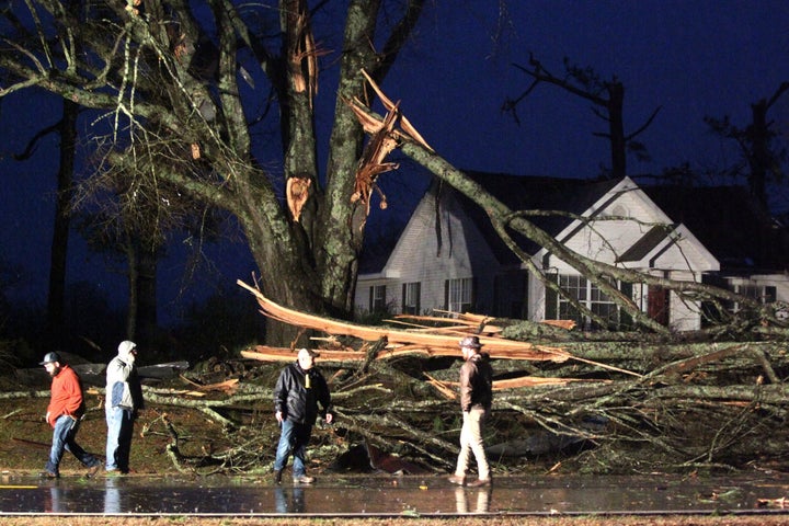 Lee County officials and the Pratts-Friendship Fire Department work to check an area on Highway 370 near Baldwyn, Miss., Monday, Dec. 16, 2019, as they clear debris from the road after a tornado passed through the area. (Adam Robison/The Northeast Mississippi Daily Journal via AP)