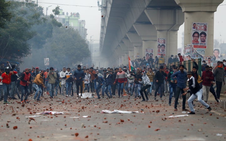 Demonstrators throw pieces of bricks towards riot police during a protest against a new citizenship law in Seelampur, area of Delhi, India December 17, 2019. REUTERS/Danish Siddiqui