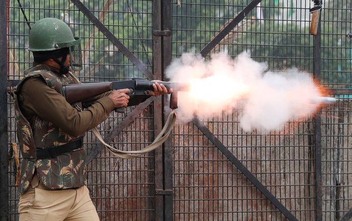 A riot police officer fires tear gas towards demonstrators during a protest against a new citizenship law in Seelampur, area of Delhi, India December 17, 2019. REUTERS/Danish Siddiqui