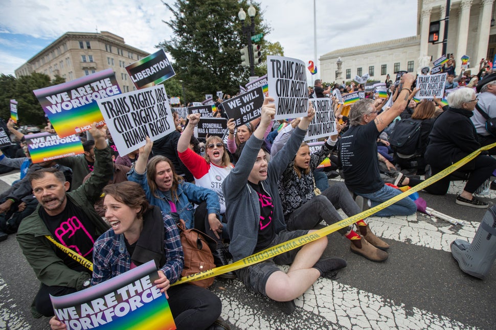 LGBTQ rights protesters demonstrate outside the Supreme Court, which is considering multiple cases that could roll back the l