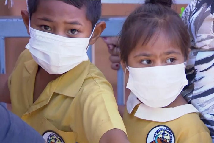 Masked children wait to get vaccinated at a health clinic in Apia, Samoa, in November after an emergency due to a measles out