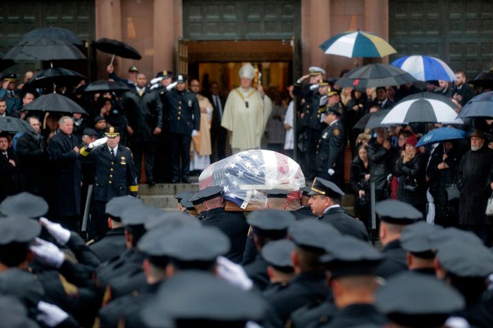 Pallbearers transport the casket of Jersey City Police Detective Joseph Seals in to St. Aeden's church for the funeral services in Jersey City, N.J., Tuesday, Dec. 17, 2019. 