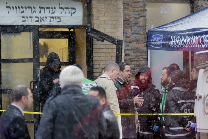 Jersey City's mayor Steven Fulop, center right, talks with first responders at the scene of a shooting in Jersey City, N.J.,