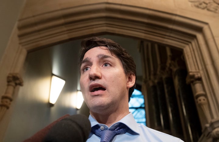 Prime Minister Justin Trudeau speaks with the media as he makes his way to a caucus meeting in West block on Dec. 11, 2019 in Ottawa.