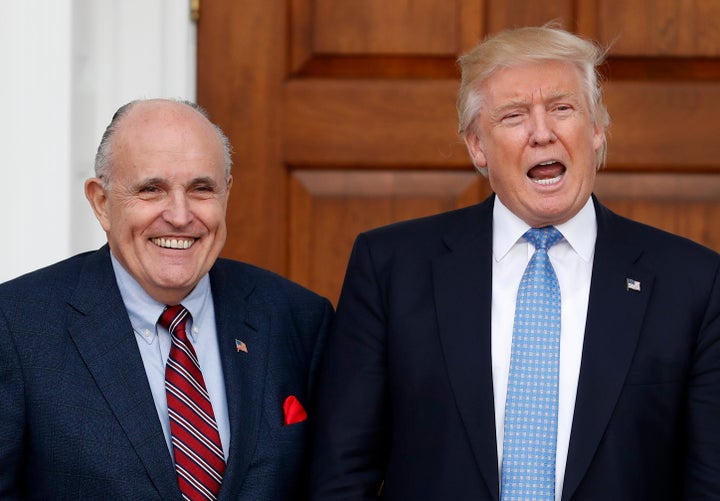 President-elect Donald Trump calls out to media as he and former New York Mayor Rudy Giuliani pose for photographs as Giuliani arrives at the Trump National Golf Club Bedminster clubhouse, Sunday, Nov. 20, 2016, in Bedminster, N.J.