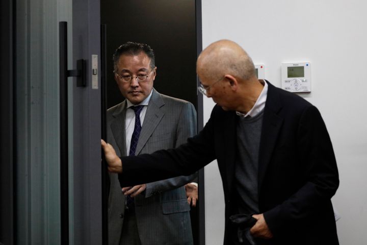 Noriyuki Yamaguchi, left, a former television reporter who is accused of sexually assaulting a female journalist, arrives for a news conference Wednesday, Dec. 18, 2019, in Tokyo. A Japanese civil court awarded about $30,000 in damages to the journalist who alleged she was raped by Yamaguchi in a case that highlighted Japan's outdated rape laws and the obstacles women face in alleging sexual misconduct in a nation run by a conservative, male-dominated establishment. (AP Photo/Jae C. Hong)
