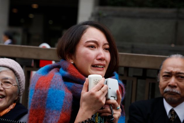 Freelance journalist Shiori Ito sheds tears while talking to her supporters outside a courthouse Wednesday, Dec. 18, 2019, in Tokyo. A Tokyo court awarded compensation to Ito in a high-profile rape case which prosecutors had once dropped their criminal investigation into an alleged attacker known for his close ties with Prime Minister Shinzo Abe and his ultra-conservative supporters.(AP Photo/Jae C. Hong)