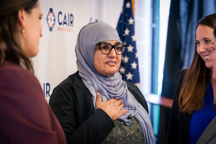 Aida Shyef Al-Kadi (center) reached a settlement with Ramsey County for $120,000 after claiming religious discrimination for being forced to remove her hijab for a booking photo.