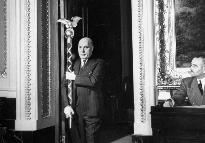 The sergeant-at-arms carries the ceremonial mace into the House of Representatives in 1941.