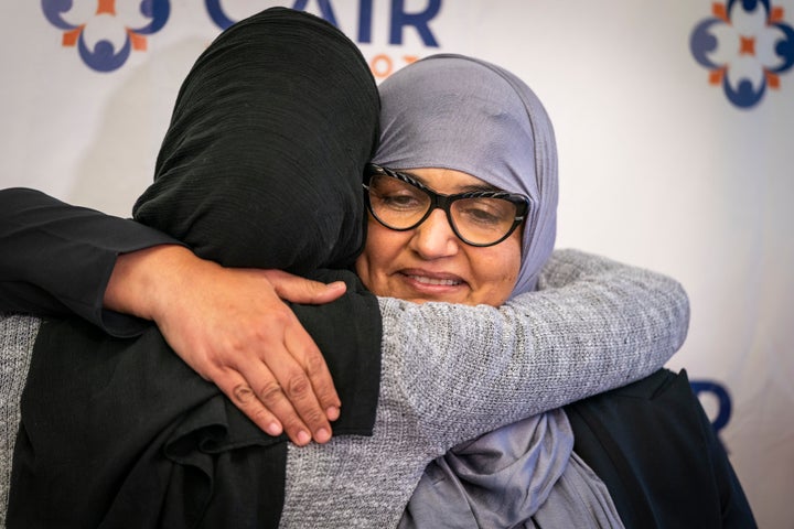 Aida Shyef Al-Kadi, right, hugs Asma Mohammed, advocacy director at Reviving the Islamic Sisterhood for Empowerment, after a press conference at CAIR's Minnesota headquarters.