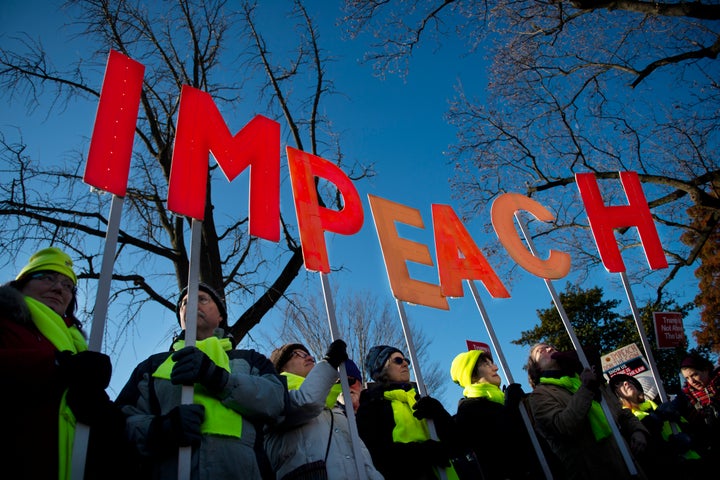 People rally in support of the impeachment of President Donald Trump in front of the Capitol as the House of Representatives