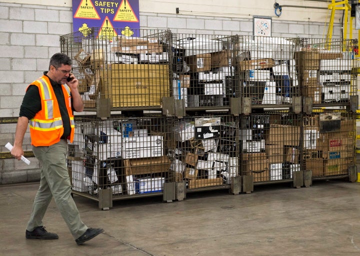 Containers full of parcels await delivery at Canada Post's Gateway location in Mississauga, Ont. on Jan. 24, 2018.