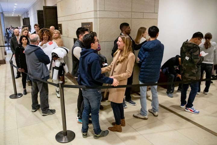 Members of the public, killing time while waiting to get into the House chamber.