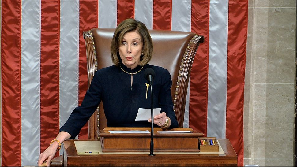 House Speaker Nancy Pelosi of Calif., announces the passage of the first article of impeachment, abuse of power, against President Donald Trump by the House of Representatives at the Capitol in Washington on Wednesday.