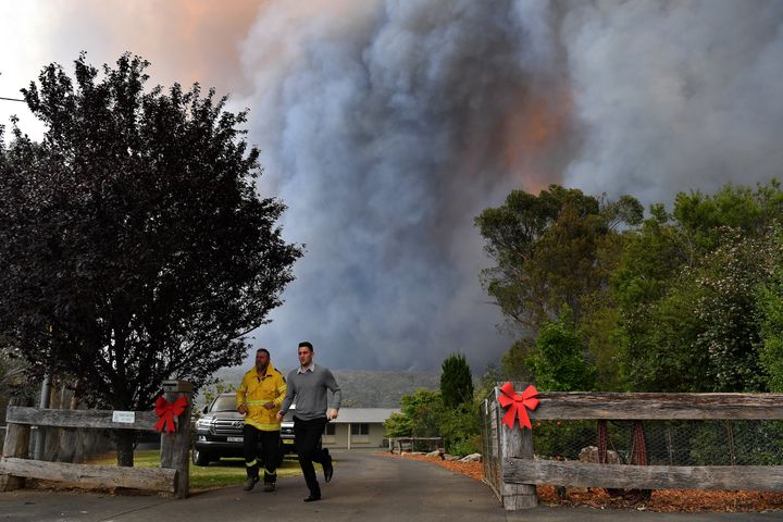 Rural Fire Service (RFS) crews engage in property protection of a number of homes along the Old Hume Highway near the town of Tahmoor as the Green Wattle Creek Fire threatens a number of communities in the southwest of Sydney.