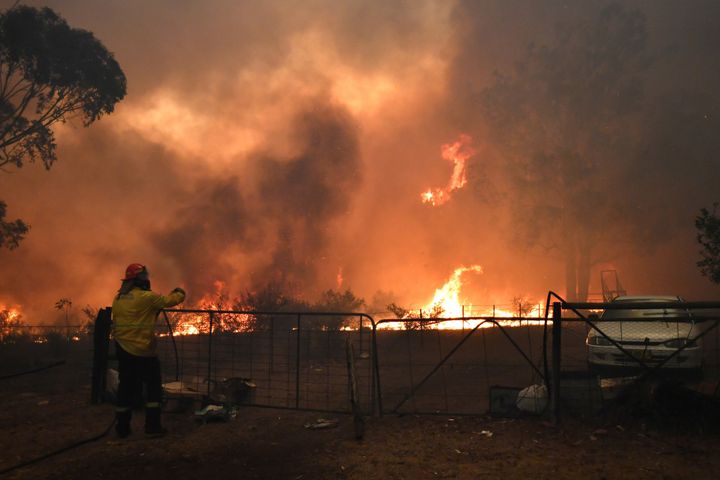 Rural Fire Service (RFS) crews engage in property protection of a number of homes along the Old Hume Highway near the town of Tahmoor as the Green Wattle Creek Fire threatens a number of communities in the southwest of Sydney, Australia.