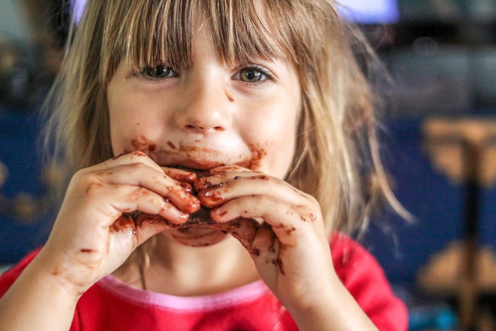 Little girl with a face full of chocolate food