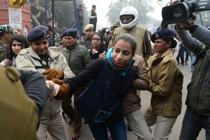 Police detain a woman at a demonstration against CAA in New Delhi on December 19, 2019. 