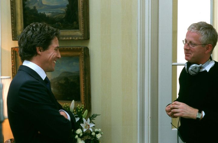Hugh Grant (left) and Richard Curtis on the Love Actually set in 2002.