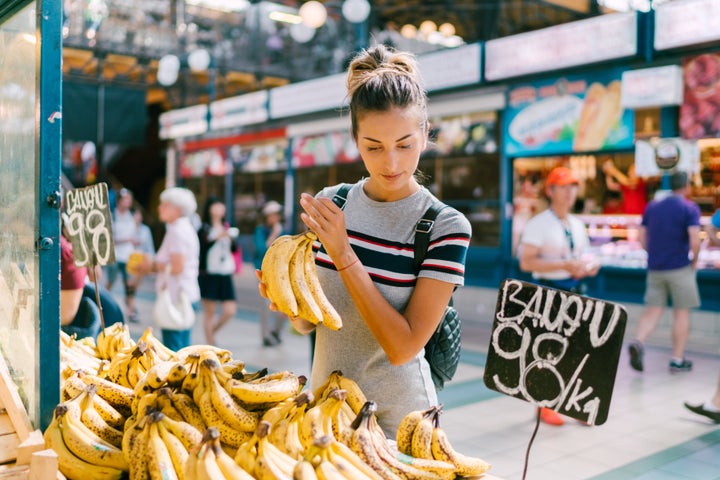 Tourist woman in Budapest buying fresh fruits