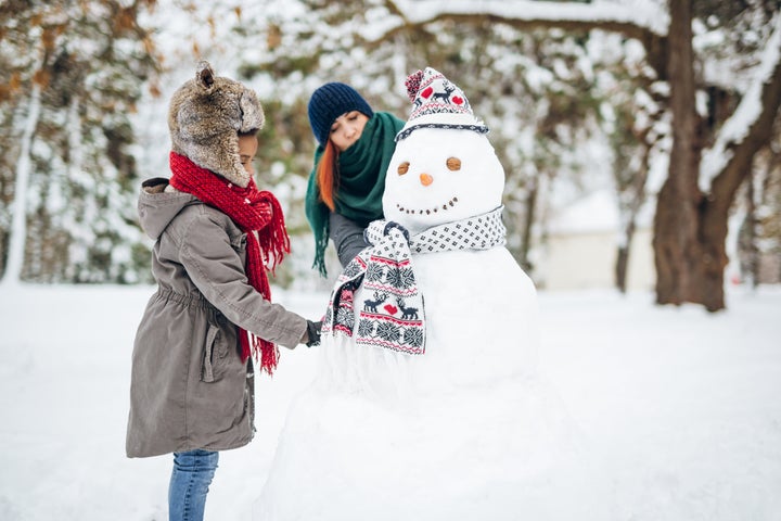 Enjoying winters magics with beloved ones, having fun and making a snowman