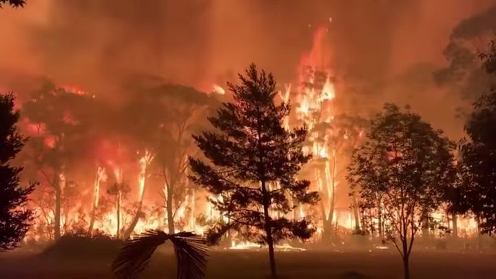 A fire blazes across bush as seen from Mount Tomah in New South Wales, Australia December 15, 2019 in this still image obtained from social media video. NSW RFS