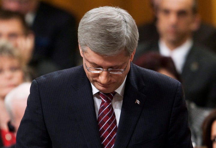 Stephen Harper rises in the House of Commons after his government was defeated on a Liberal contempt of Parliament motion in Ottawa on March 25, 2011.