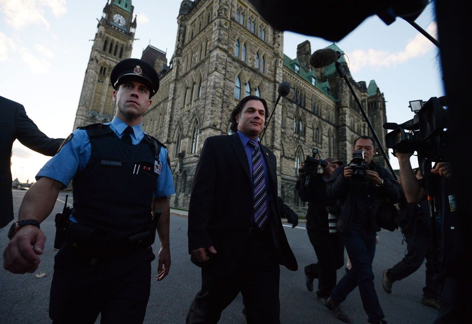 Senator Patrick Brazeau leaves the Senate on Parliament Hill in Ottawa on Wednesday, October 23, 2013.