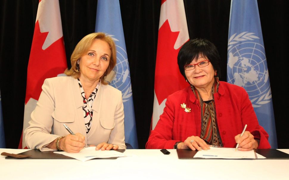 International cooperation minister Beverley Oda (right) and Josette Sheeran (left), executive director of the United Nations World Food Programme, sign a five-year strategic partnership framework in Ottawa on Oct. 25, 2011.