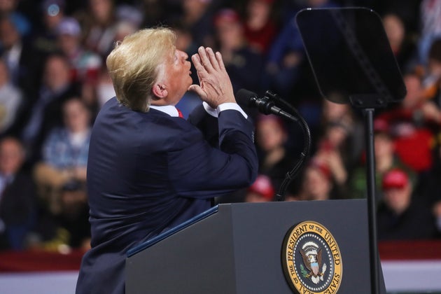 U.S. President Donald Trump reacts while speaking during a campaign rally in Battle Creek, Michigan,...