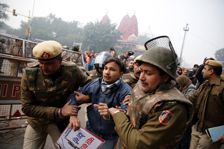 Police detain a protester during a march near the historic Red Fort in New Delhi on Thursday.