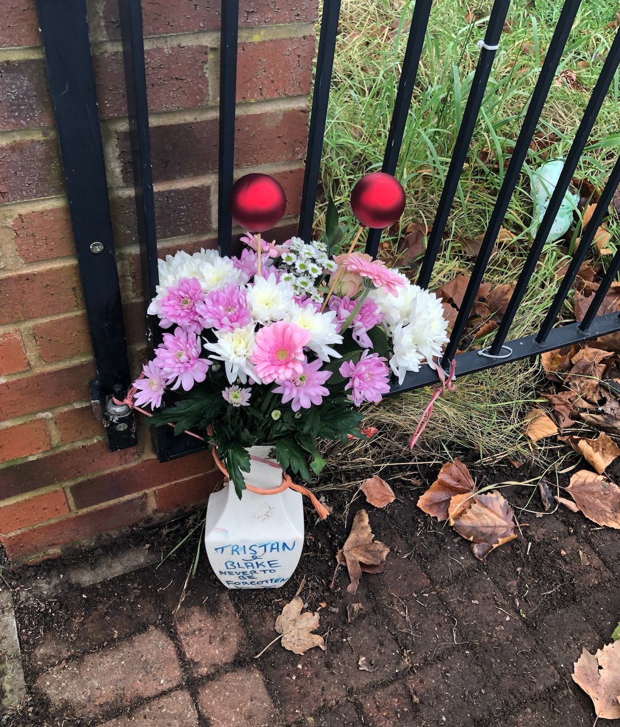 A vase of flowers outside the house