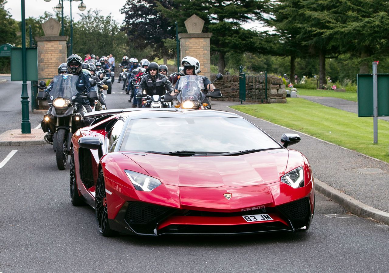 Lamborghinis and motorbikes escort the funeral cortege arriving at Grenoside Crematorium, Sheffield, prior to the funeral of Tristan and Blake Barrass.
