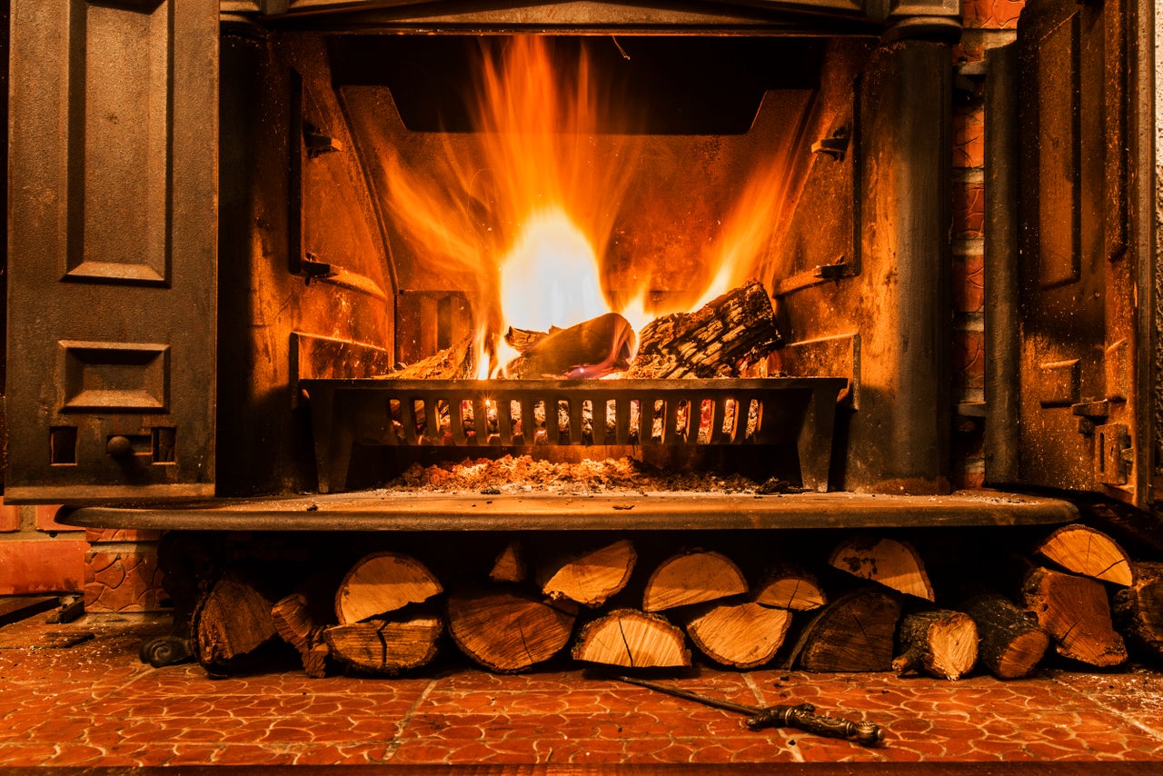 Roaring fire in an arched stone fireplace, Cozy blazing fire in fireplace