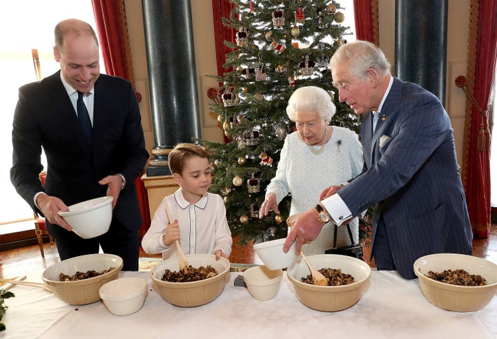 Queen Elizabeth II, the Prince of Wales, the Duke of Cambridge and Prince George preparing special Christmas puddings.