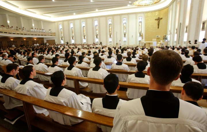 Prelates pray during a mass celebrated by Cardinal Velasio De Paolis in the Legion of Christ main headquarters, the Ateneo Po
