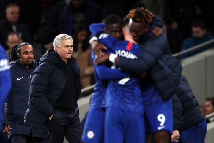 Chelsea players celebrate victory as Tottenham Hotspur manager Jose Mourinho looks on during the Premier League match at Tottenham Hotspur Stadium, London.