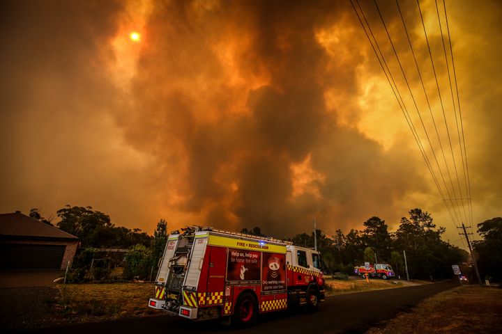 Firemen prepare as a bushfire approaches homes on the outskirts of the town of Bargo on December 21, 2019 in Sydney, Australia. 