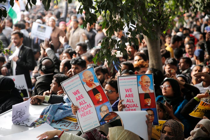 Indians hold placards during protests against India's new citizenship law in Lucknow, India, Thursday, Dec. 19, 2019.