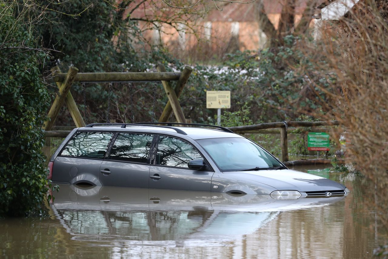 A submerged car in Yalding, Kent, after the area flooded following heavy rain which has disrupted the Christmas travel plans of millions.
