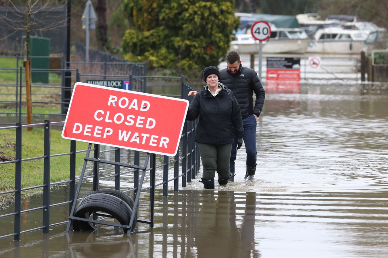 Residents wade through floodwater in Yalding.