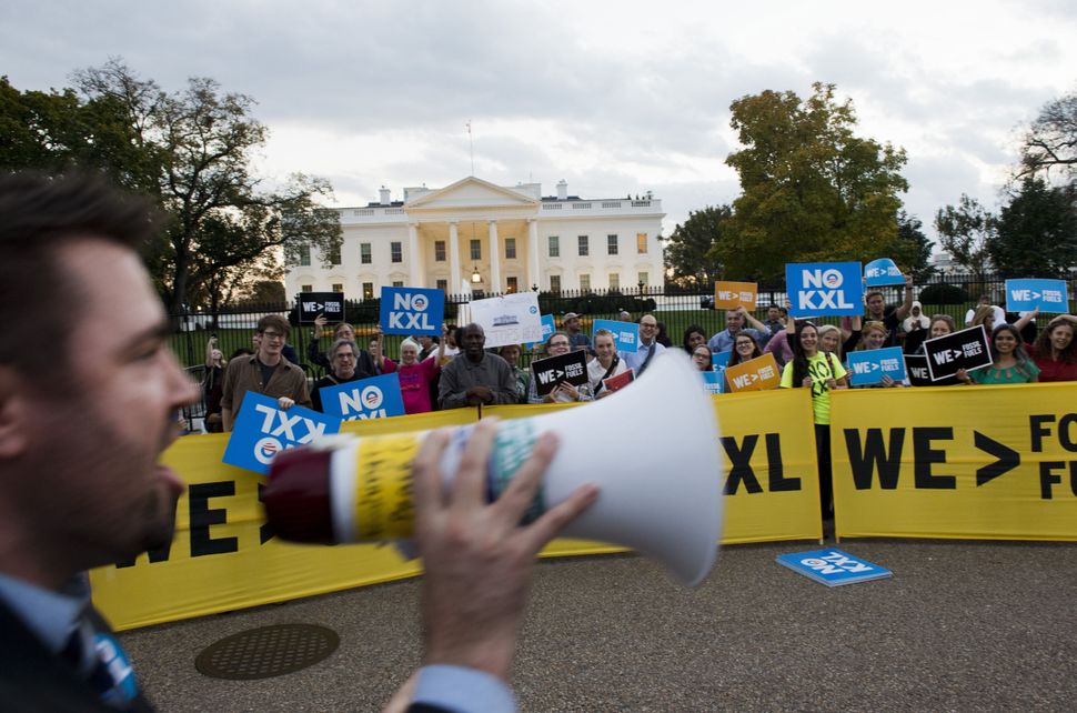 Demonstrators celebrate then-U.S. president Barack Obama's blocking of the Keystone XL oil pipeline in front of the White House in Washington, D.C., on Nov. 6, 2015. U.S. President Donald Trump subsequently approved the project, but its construction is stalled due to a lawsuit.