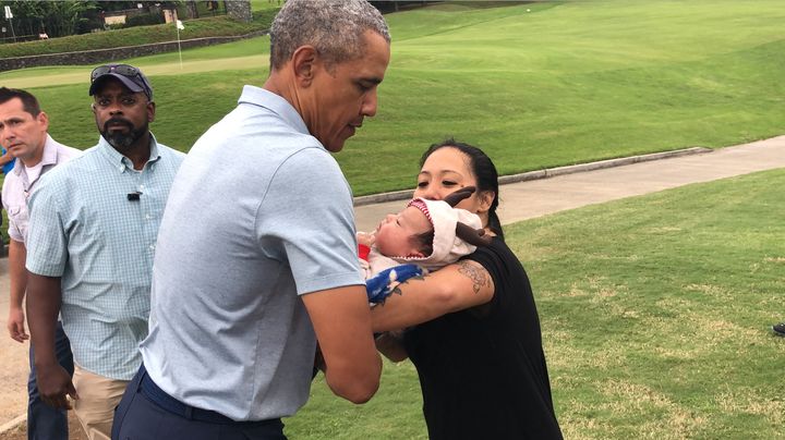 Krystle Ilar hands her 2-month-old, Levi, to Barack Obama.