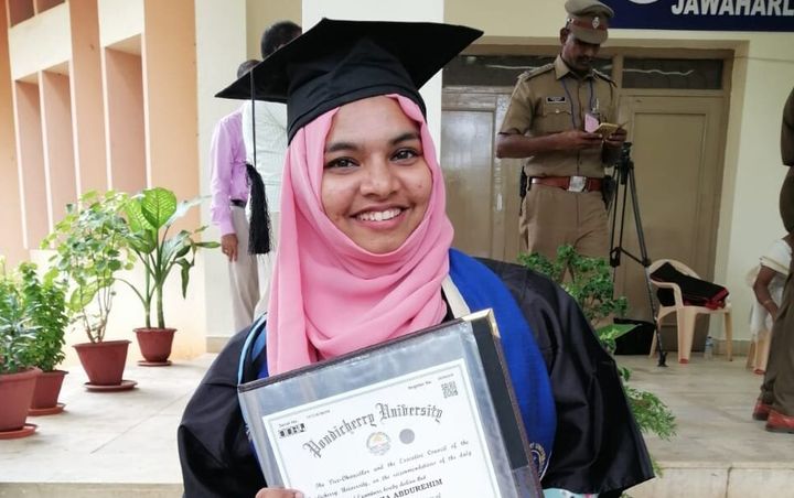 Rabeeha Abdurehim with her degree. She refused to accept the gold medal. 