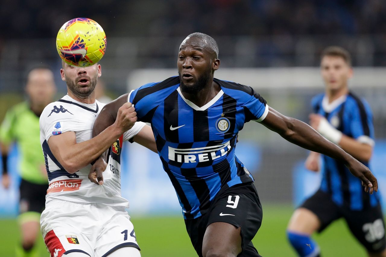 Inter Milan's Romelu Lukaku, foreground right, and Genoa's Davide Biraschi vie for the ball during a Serie A soccer match between Inter Milan and Genoa, at the San Siro stadium in Milan, Italy.