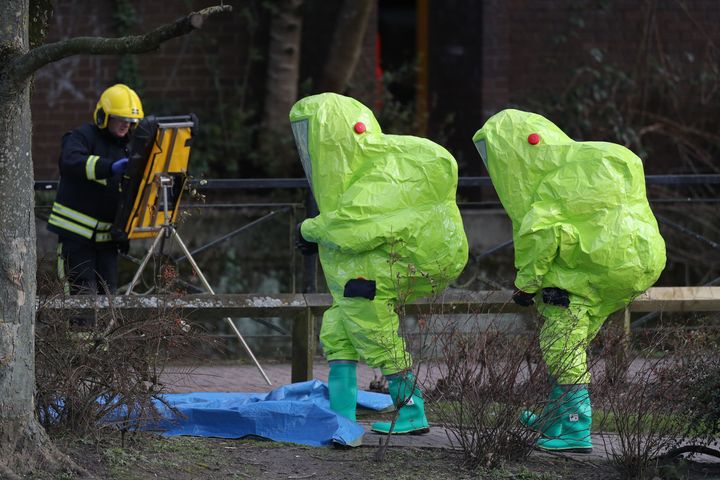 Personnel in hazmat suits waiting for decontamination after securing a tent covering a bench in the Maltings shopping centre in Salisbury, where former Russian double agent Sergei Skripal and his daughter Yulia were found critically ill by exposure to nerve agent novichok.