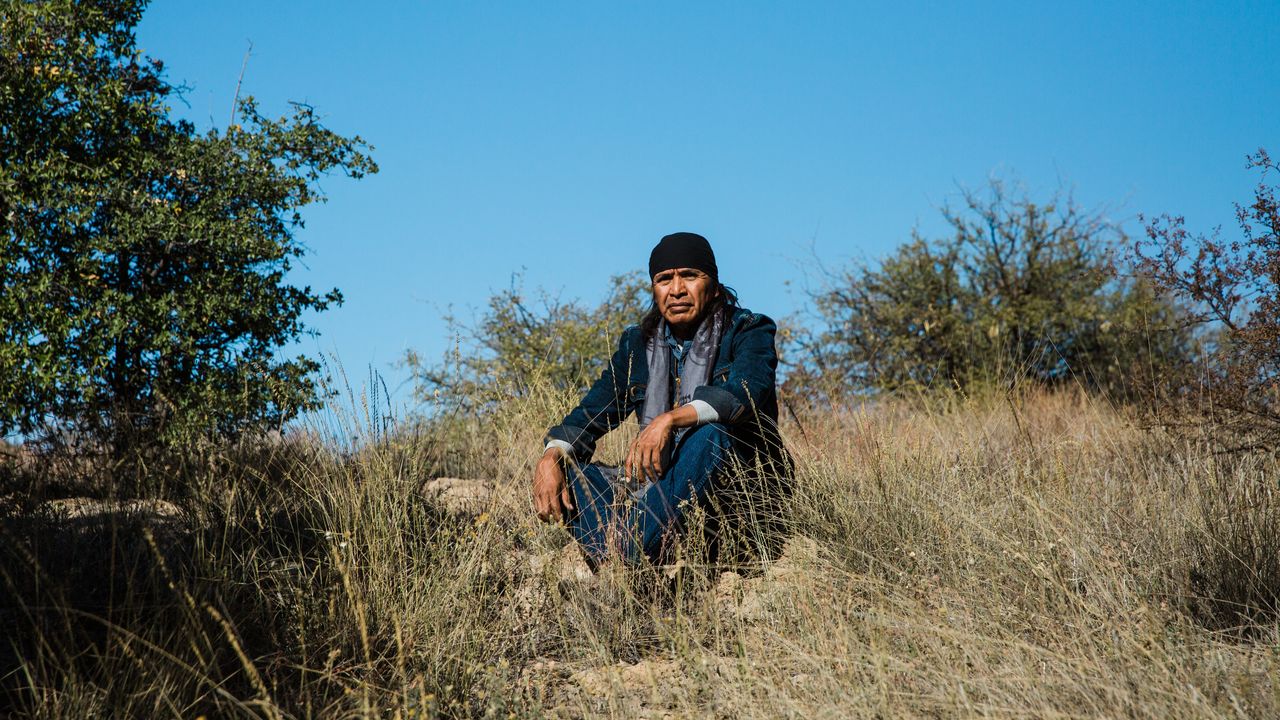 Wendsler Nosie Sr., 60, sits for a portrait at Chich’il Bildagoteel (Oak Flat) on Nov. 17. The former chairman of the San Carlos Apache Tribe walked 44 miles from Nov. 28 through Dec. 1 from the San Carlos Apache reservation to Oak Flat, where he plans to stay. “We can all stand up together. We can fix this. We can begin to heal and really develop leaders with a new mission — and that is to protect what's left so that our children will have the opportunity to live,” Nosie said. The Nosie-Pikes are enrolled in the San Carlos Apache Tribe, but they're Chiricahua Apache, one of the bands that were imprisoned in the San Carlos reservation after the Apache Wars with the United States in the 1800s.