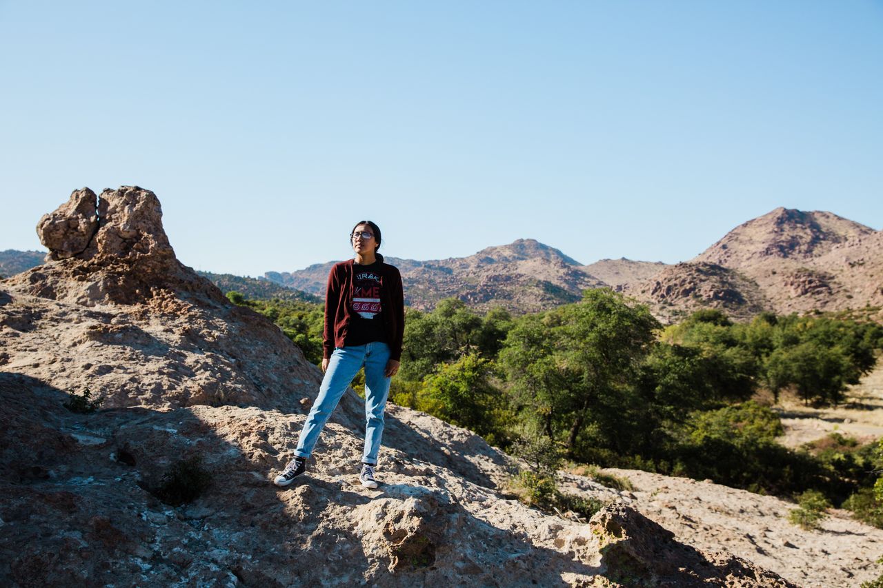Naelyn Pike, 20, a co-leader of Apache Stronghold, stands overlooking sacred land at Chich’il Bildagoteel (Oak Flat) ancestral Apache land, now administered by the U.S. Forest Service, on Nov. 17. Along with her grandfather Wendsler Nosie, her mother, Vanessa Nosie, her sisters Nizhoni and Báásé, and her aunts and cousins, Pike is fighting to keep Apache sacred sites from being developed and sold by energy corporations.