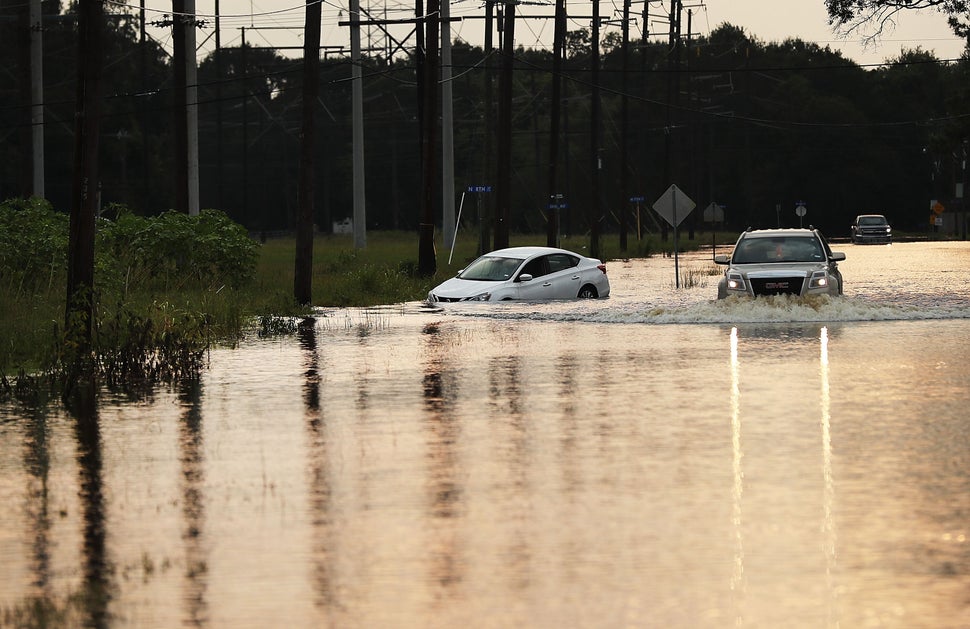 A truck drives through high water on a street as Orange, Texas, slowly moves toward recovery almost a week after the devastat