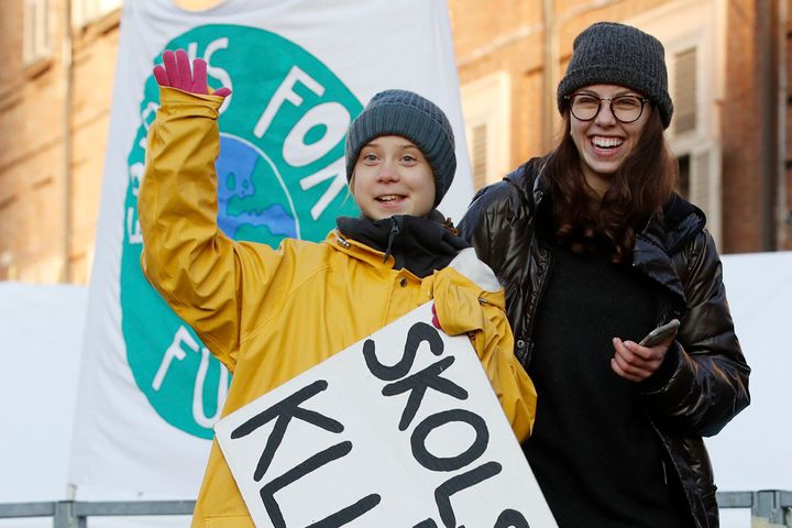 Greta Thunberg holds a sign with writing in Swedish that says, "School strike for the climate" as she attends a climate march, in Turin, Italy, in December.